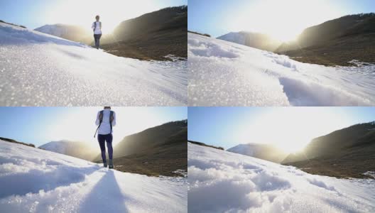 低角度的女人的脚走在雪山小径高清在线视频素材下载