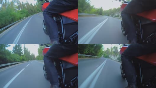 视频显示一名男子骑着一辆红色摩托车行驶在弯道上高清在线视频素材下载