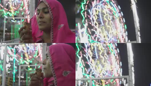 印度普什卡梅拉狂欢节上，一名拉贾斯坦邦妇女正在吃冰淇淋高清在线视频素材下载