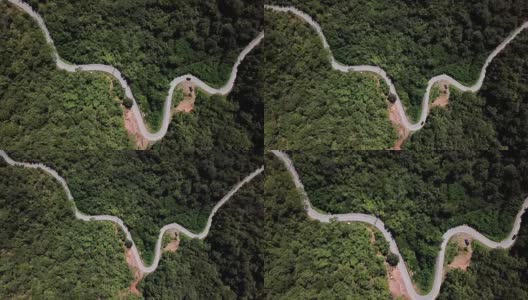 鸟瞰图蜿蜒的道路在森林和汽车驾驶，安全驾驶的概念高清在线视频素材下载