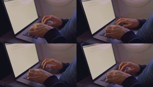 一名男子在飞机上敲打笔记本电脑——近距离观察高清在线视频素材下载