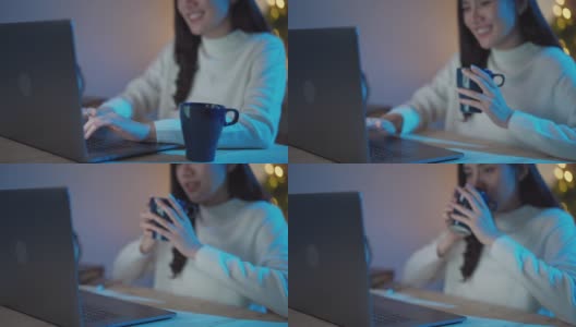 快乐的自由职业者，晚上在公寓边喝咖啡边用笔记本电脑工作高清在线视频素材下载