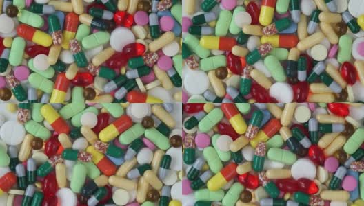俯视图不同颜色的药丸旋转的圆圈。药物和药物。制药行业。高清在线视频素材下载