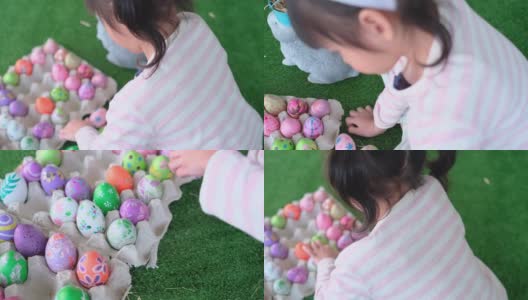 俯视图小女孩玩的时候把复活节彩蛋放进嵌板里，和妹妹一起享受高清在线视频素材下载