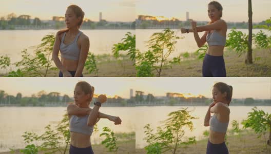 新常态的户外运动，年轻的亚洲健身运动女性伸展她的身体在户外锻炼前热身。为了健康和幸福，穿着运动服的女孩在黄昏时分在户外锻炼。高清在线视频素材下载