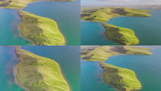 在青藏高原的湖中，有一个充满绿色草原的半岛高清在线视频素材下载