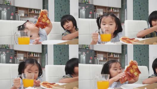 快乐的亚洲女孩喜欢在假期的午餐时间在家吃披萨高清在线视频素材下载