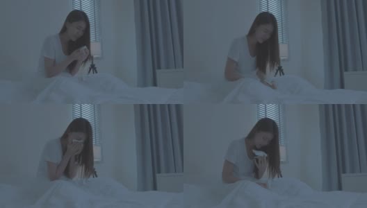 穿着睡衣的亚洲生病女孩在床上打喷嚏。有吸引力的年轻女子感觉不好，遭受过敏，把纸巾盖住她的鼻子，而在睡觉时打喷嚏在房子。高清在线视频素材下载