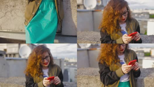 日落时分，一个年轻女子站在屋顶上，拿着手机。缓慢的莫高清在线视频素材下载