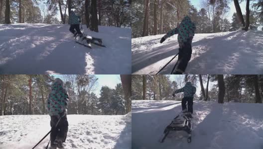 可爱的小男孩在下雪的冬天拉着雪橇爬山高清在线视频素材下载