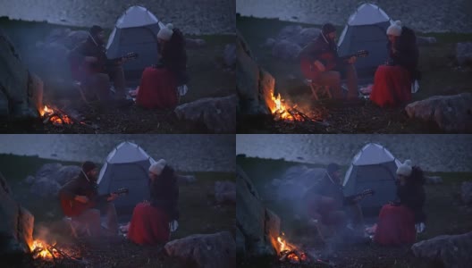 黄昏时分，一对旅行者在篝火旁高清在线视频素材下载