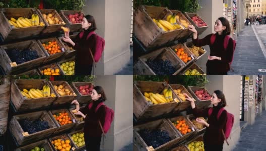 在佛罗伦萨的街上挑选新鲜水果的女人高清在线视频素材下载