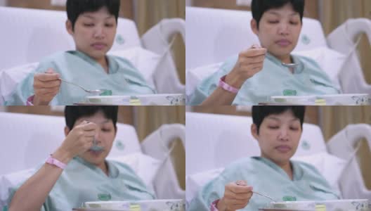 女病人在医院病床上吃饭高清在线视频素材下载