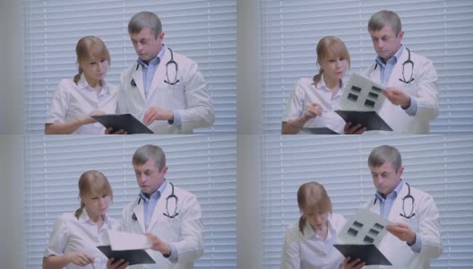 两位医生在看病人的病史高清在线视频素材下载
