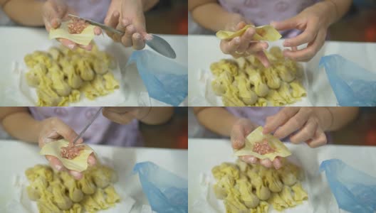 亚洲妇女手工制作馄饨和饺子馅。高清在线视频素材下载
