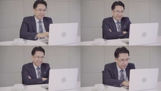 慢动作-成功的亚洲首席执行官，商人穿着西装在办公室的办公桌上用笔记本电脑工作。商人的工作理念。高清在线视频素材下载