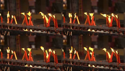 寺庙中红色蜡烛燃烧时火焰的慢镜头高清在线视频素材下载