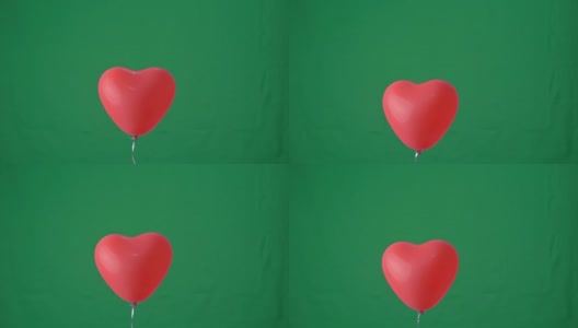 红色心形氦气球孤立在绿色屏幕背景上，情人节，生日派对设计概念，4K，工作室拍摄，慢动作。高清在线视频素材下载