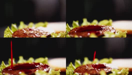 用厨房慢动作将番茄酱倒在汉堡上高清在线视频素材下载