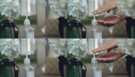 慢动作女人的手在桌上使用洗手液高清在线视频素材下载