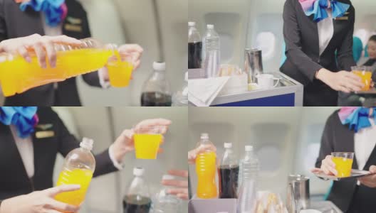 美丽的空姐提供橙汁的年轻乘客在喷气式飞机。高清在线视频素材下载