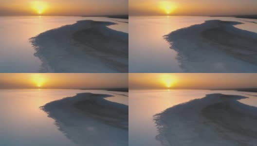 夕阳把盐湖的湖水染成了橘红色高清在线视频素材下载