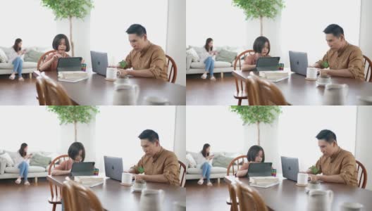 父亲在家工作，女儿在玩平板电脑高清在线视频素材下载