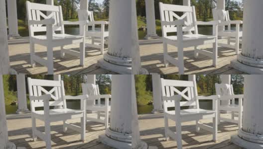 爱沙尼亚凉亭上的白色小木椅高清在线视频素材下载