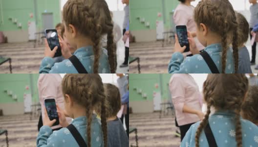 小女孩用智能手机拍照高清在线视频素材下载