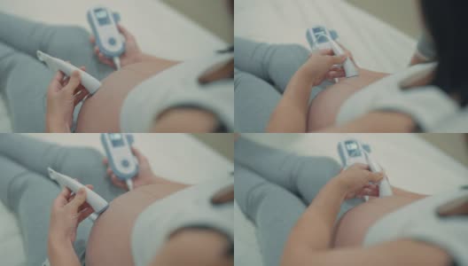 孕妇使用胎儿多普勒听婴儿心跳高清在线视频素材下载