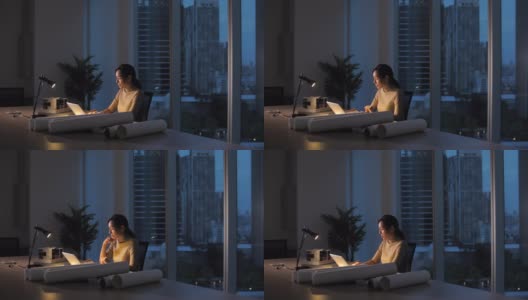 在晚上工作到很晚的亚洲妇女高清在线视频素材下载