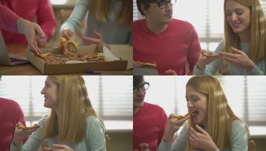 年轻迷人的女人和英俊的男人吃着热美味的披萨。高清在线视频素材下载