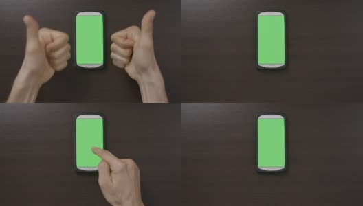 千禧一代的男人在绿色屏幕智能手机前做手势，用大拇指向上OK心的手指手势评估应用程序高清在线视频素材下载