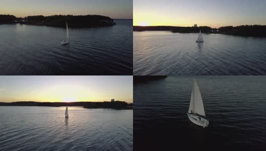 令人惊叹的日落颜色。河面上漂浮着帆船的剪影。高清在线视频素材下载