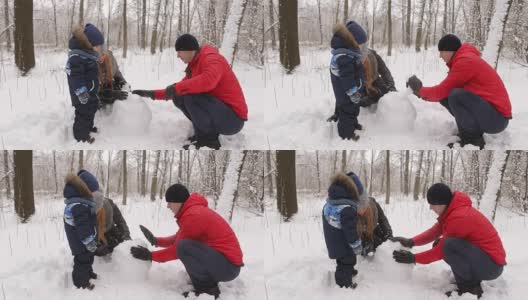 一家人和孩子们在公园堆雪人。高清在线视频素材下载