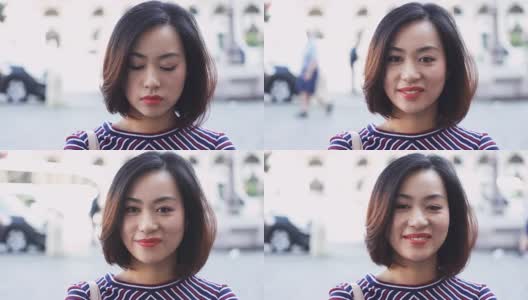 年轻的亚洲女人在城市的一天，微笑快乐的脸肖像高清在线视频素材下载