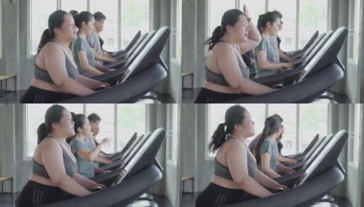 人们在健身房的跑步机上行走高清在线视频素材下载