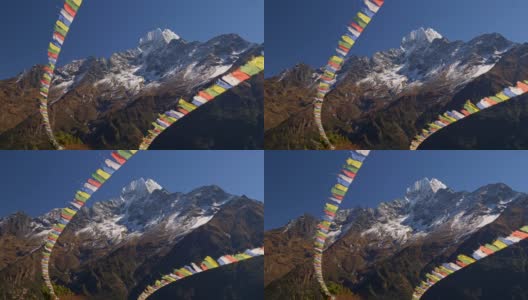 尼泊尔。绘有佛经的彩旗在强风中飘扬。背景是白雪覆盖的喜马拉雅山脉。UHD高清在线视频素材下载