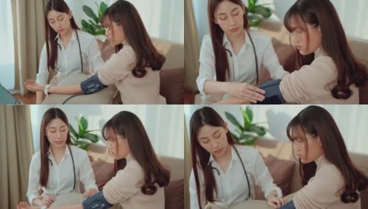 一位亚洲女医生正在给这位年轻的女病人在家测量血压。高清在线视频素材下载