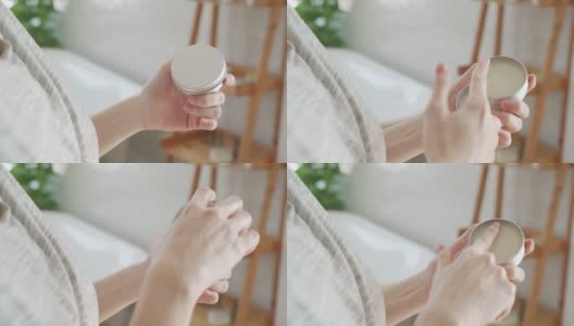 女性双手打开护手霜从最小的浴室包装。用手指擦香油的女人。高清在线视频素材下载