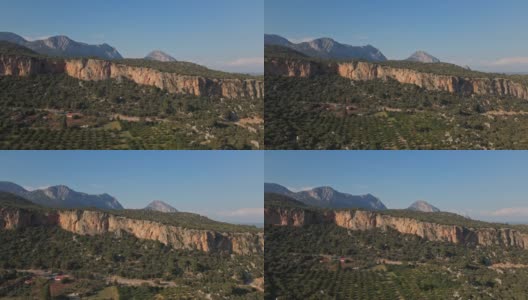 从无人机俯瞰橄榄花园，露营，惊人的石灰岩悬崖岩壁和山脉的美丽风景。土耳其Geyikbayiri附近的登山营地高清在线视频素材下载