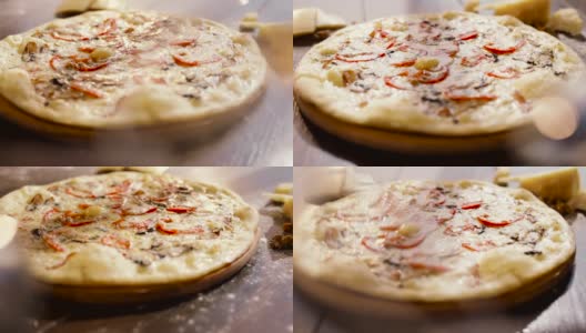 木盘上美味披萨的慢动作。白酱披萨，蕃茄，辣椒，鸡蛋在前景。意大利菜。背景中有一块奶酪。开胃菜高清在线视频素材下载