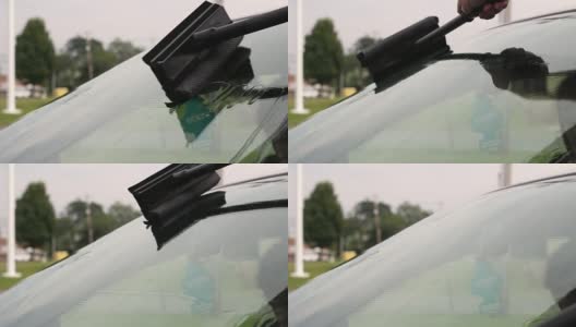 一名男子在加油站用橡皮擦擦挡风玻璃高清在线视频素材下载