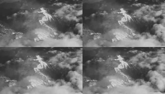 Vintage Black And White Aerial View of Clouds And Snow Covered Alps Mountains高清在线视频素材下载