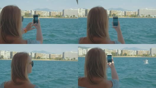 女人与细胞射击大海和城市从船上高清在线视频素材下载