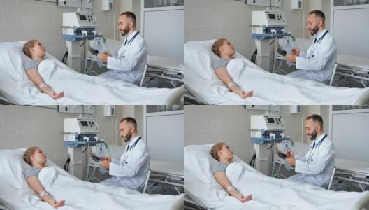 医生坐在病床附近和年轻的女病人讨论高清在线视频素材下载