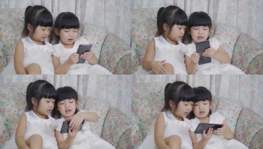 两个用手机的小女孩高清在线视频素材下载
