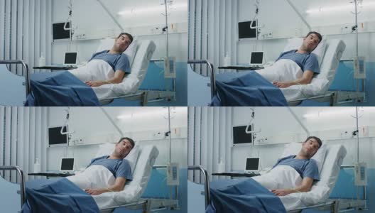 一个重病人躺在医院的病床上。监视器显示了他的生命体征。病房是干净的和新的。高清在线视频素材下载