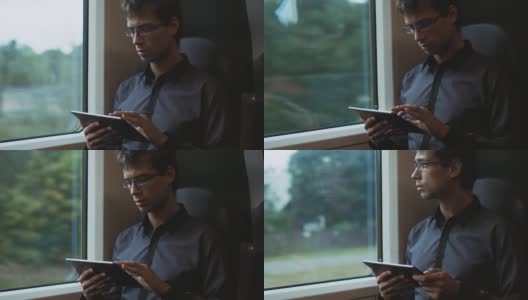 一名男子在火车上使用平板电脑高清在线视频素材下载