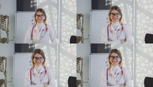 年轻女医生戴眼镜和白大褂与听诊器在颈部微笑在医院的办公室。37、医生养生，爱医医高清在线视频素材下载